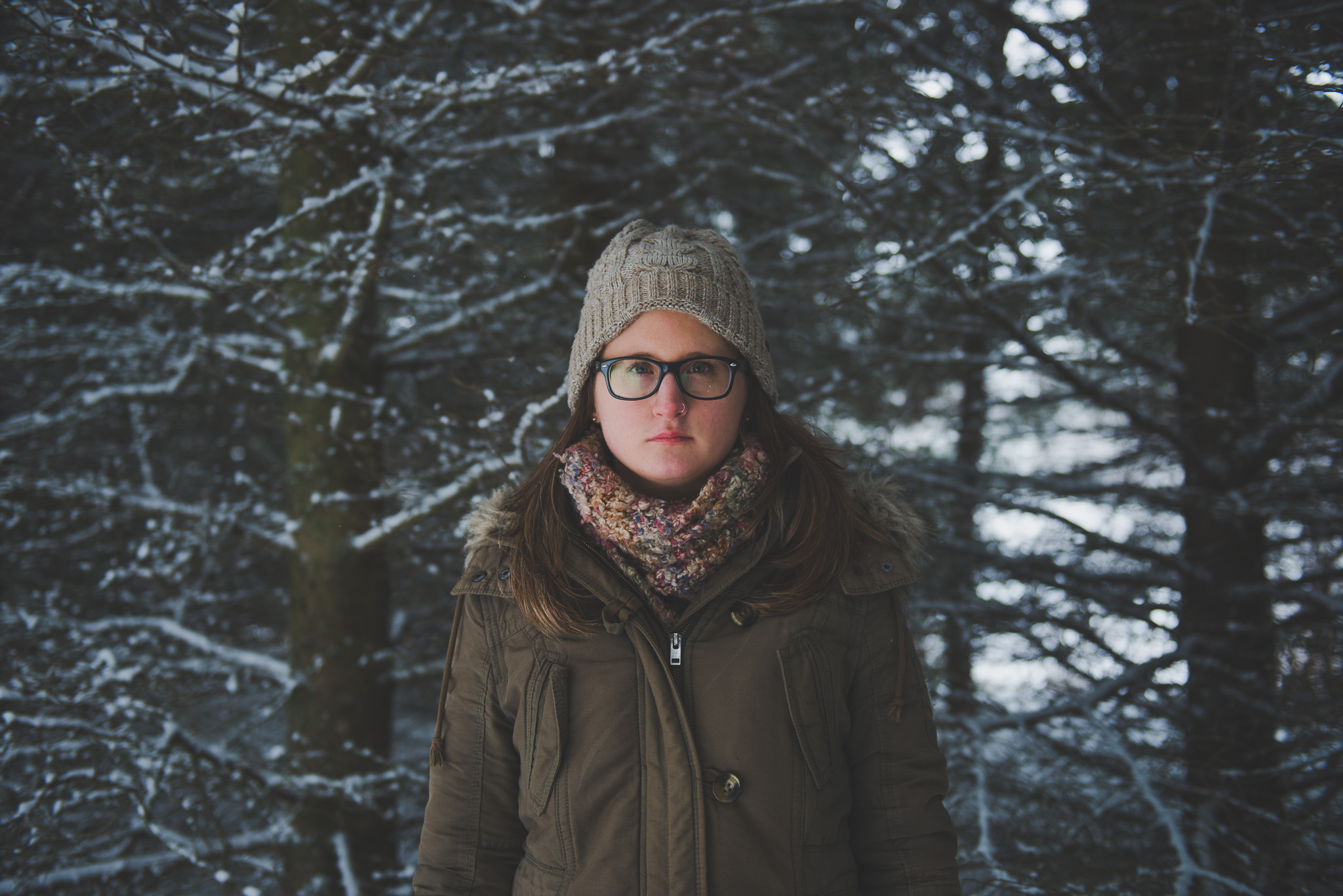 Snow, portrait, woods, toque, dark,  winter, ontario, Canada, Toronto photographer, Port Hope photographer, woman, glasses, woods, trees 